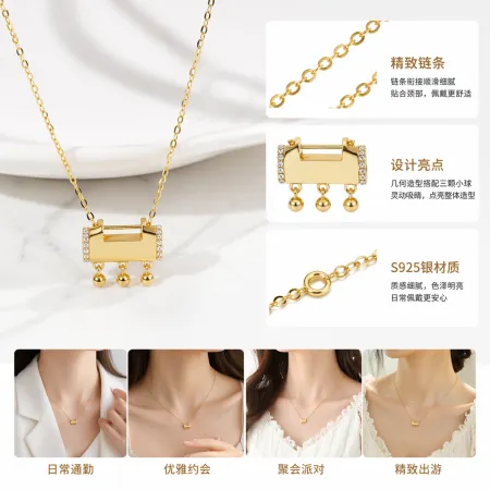 A golden rectangular small bell pendant necklace, held in a transparent bag with a white card A golden rectangular small bell pendant necklace, held in a transparent bag with a white card